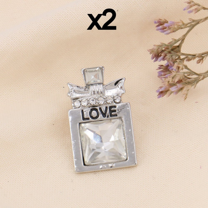 Pin's X2 flacon de parfum love métal strass 0623506 argenté Pin's X2 flacon de parfum love métal strass 0623506 argenté