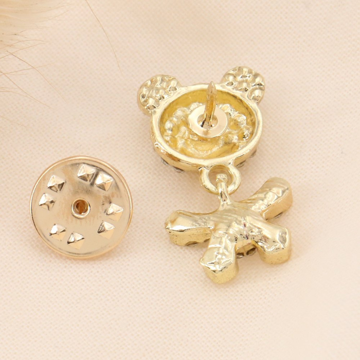 Pin's x2 nounours articulé et strass blancs 0623511 doré