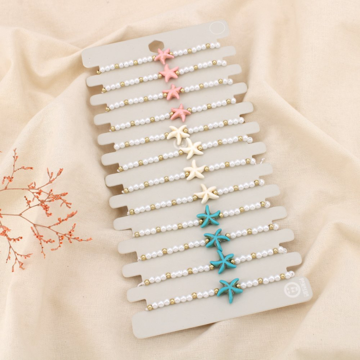 Lot de 12 bracelets fantaisie coulissants Étoile de mer et perles 0225206 multi Lot de 12 bracelets fantaisie coulissants Étoile de mer et perles 0225206 multi