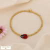 Bracelet élastique billes acier inoxydable breloque coccinelle émail 0225035 rouge